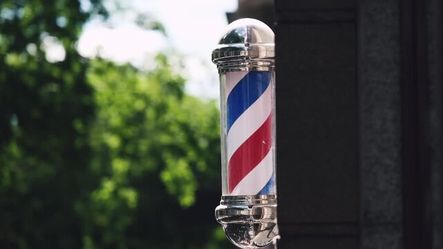 Rotating Barber Pole On A Street At The Facade Entrance Of A Barber Shop