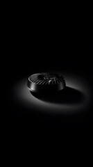 Elegant metal cuff bracelet under a dramatic spotlight.