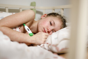 Young Girl Resting in Bed with Thermometer