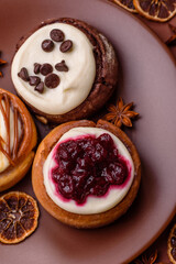 Cinnamon roll, a sweet bun with citrus, cherries, and chocolate, a Danish dessert with cream