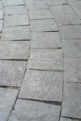 gray stone or tiles road, a beautiful background for the designer with empty space. Vertical photo