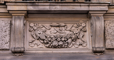 decorative sculpture of fruits on the facade of old building