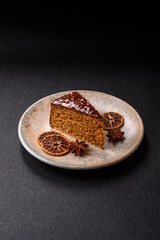 A slice of sweet layered cake covered in chocolate with nuts and caramel. A slice of chocolate cake
