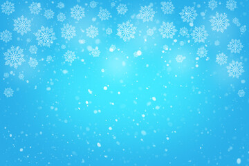 Winter blue background with falling snowflakes and soft glow for festive holiday theme