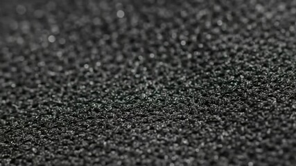 Intricate Macro View of Tiny Black Granules Shifting and Flowing in Slow Motion. - Powered by Adobe