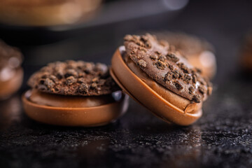 Sweet chocolate pralines. Chocolate candies on black table.