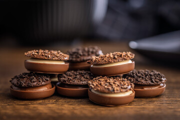 Sweet chocolate pralines. Chocolate candies on wooden table.