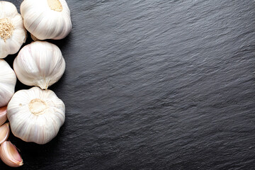 Peeled Raw Garlic Cloves on Slate Surface