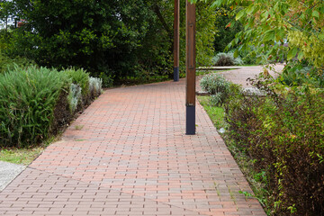 Path with brick road winding through a scenic park