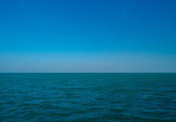 Obraz premium Photography tranquil seascape with calm sea ocean waters stretching to the horizon under a clear blue sky, evoking peace and openness.relaxing summer scene perfect for travel holliday and nature lover