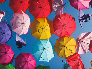 Colorful Umbrellas Hanging under blue sky