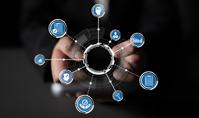This image illustrates hands interacting with a network of digital icons, representing the integration of technology and data in modern business management and analytics. Crux