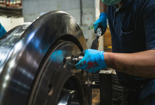 Close-up engineer technician craftsman one person hand wear glove safety protective holding wrench tool tighten torque nut standard value for job repair product in machine workshop industrial factory