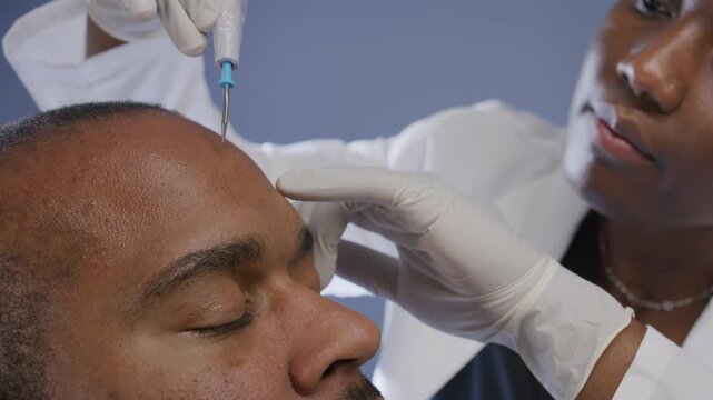 A healthcare professional performs electrodesiccation procedure on a patient's skin, showcasing expertise and care in a clinical setting.
