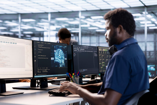 Data center professional doing AI research, implementing algorithms using machine learning. Computer scientist in server room workspace using artificial intelligence computational models
