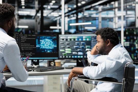 Data center supervisor and programmer with paraplegia using artificial intelligence computerized model. Server room manager and IT expert with disability using machine learning AI algorithms