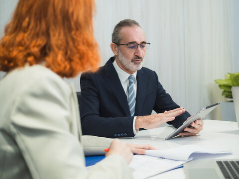 business meeting discussion among people seat around table modern office laptop on table convey collaboration communication relax working environment making suitable content related team office life.