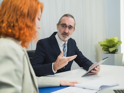 business meeting discussion among people seat around table modern office laptop on table convey collaboration communication relax working environment making suitable content related team office life.