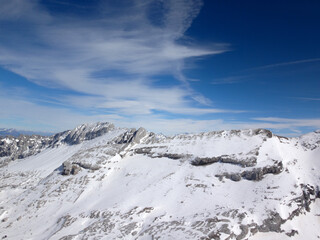 Snow-Covered Mountain Ridge with Blue Sky