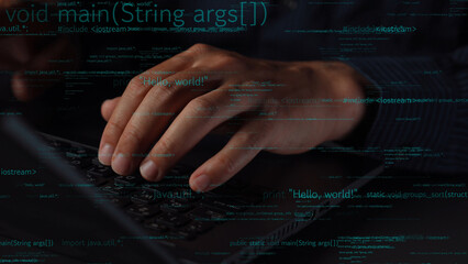 Close-up view of hands on a laptop keyboard in a dark environment, surrounded by programming code, reflecting the essence of modern technology and software development. Xenic