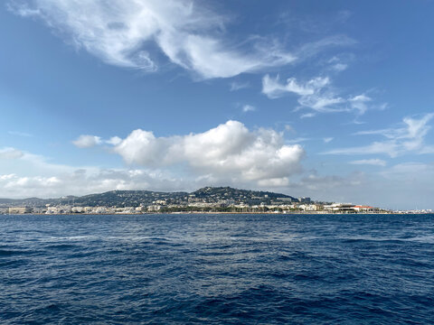 Coastal City Skyline with Sea and Clouds