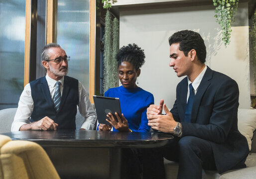 business meeting discussion among people seat around table modern office tablet on table convey collaboration communication relax working environment making suitable content related team office life.