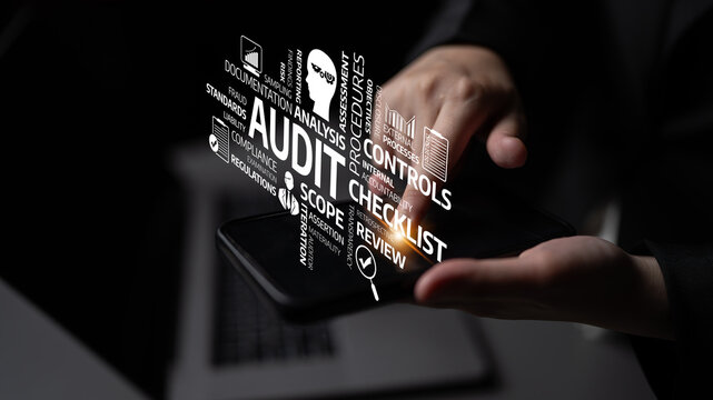 A close-up shot of hands holding a smartphone displaying a digital concept of audit, featuring keywords related to financial processes, compliance, and analysis. Tessel - Powered by Adobe