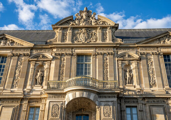 Exterior view of the Louvre Palace along the River Seine on Quai Francois Mitterrand, historic architecture in the heart of Paris, France.
