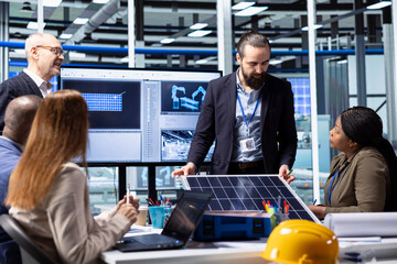 Solar panels factory management executives and investor in facility working together to finish deal. Businesspeople in photovoltaics plant cooperating on strategic solar energy investments