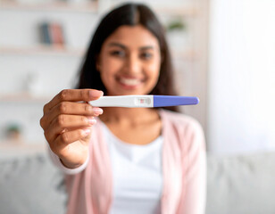 Emotional scene featuring a smiling person holding a pregnancy test.  The image conveys a moment of personal significance. Emotional storytelling, health and wellness theme, hopeful and joyful mood.