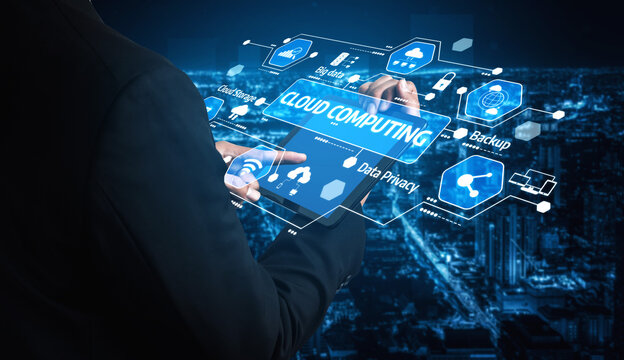 A business professional engages with an advanced cloud computing interface at night, showcasing various digital elements that reflect the future of technology. Tessel