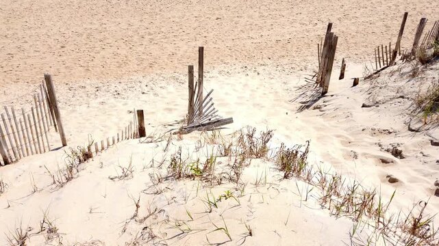 A quick pan up over sandy beaches to reveal blight BU blue beautiful ocean