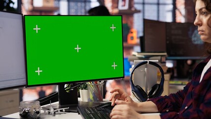 Computer scientist using green screen PC working with artificial intelligence technology in tech startup. Chroma key computer monitor used by IT specialist developing AI systems in office, close up