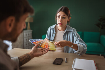Couple having disagreement choosing paint colors for home renovation
