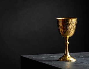 A golden, decorative gobletingrad on a dark, textured surface, evoking a sense of elegance and mystery.