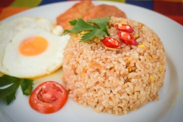 Traditional Indonesian Fried Rice with Fried Egg on White Plate