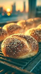 sesame rolls baking at sunset, with a glow and urban skyline in the background
