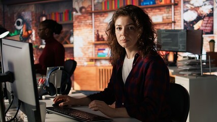 Portrait of happy woman working in AI tech agency providing custom software development services....