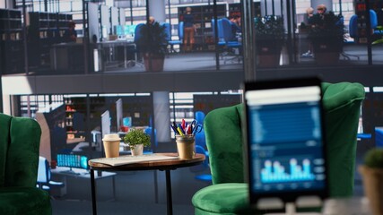 Modern office space with financial data on a monitor used for meetings, running detailed analytics and graphs. Empty workspace to develop business strategies for success, productivity tools.