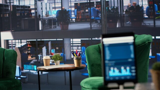 Modern office space with financial data on a monitor used for meetings, running detailed analytics and graphs. Empty workspace to develop business strategies for success, productivity tools.