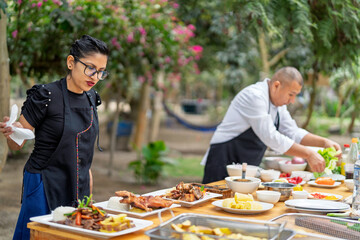 Chefs preparing peruvian dishes outdoors with fresh ingredients