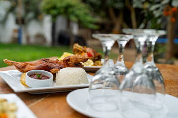 Traditional peruvian cuy chactado with rice and sauce