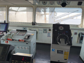 navigation bridge of the cargo ship. nautical equipment and charts 25 steering gear