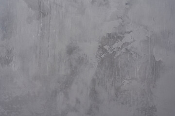 Abstract gray concrete wall texture with weathered grunge surface, paint marks, scratches and stains. Background for modern aesthetic and contemporary interior decoration projects.