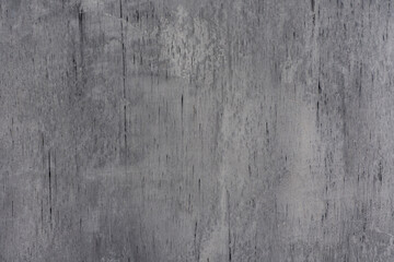Abstract gray concrete wall texture with weathered grunge surface, paint marks, scratches and stains. Background for modern aesthetic and contemporary interior decoration projects.