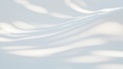 Snow texture creating abstract natural patterns with soft light and shadows cast across gentle curves and subtle undulations, forming a minimalist winter background