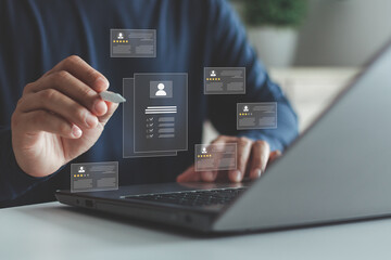 Businessman hand reviewing digital candidate profile with rating stars and checklist on laptop,...