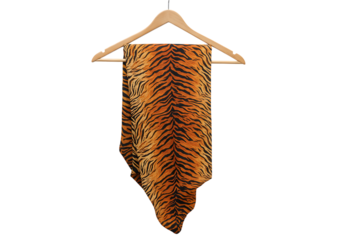Tiger print pants hanging on a wooden hanger.