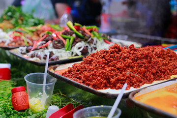 Traditional street food stand serving mexican food and tacos