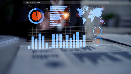 A business professional engages with a data analytics dashboard, showcasing essential graphs, charts, and a world map in a modern office environment. Impute